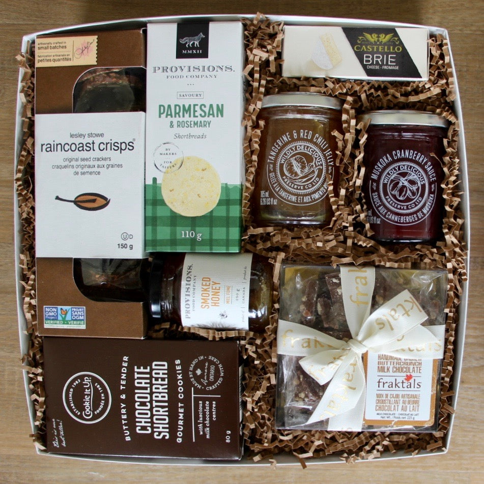 A sophisticated gourmet gift box by Perfect Baskets is filled with artisanal, small batch goodies to make a lovely charcuterie board to share with friends and family.