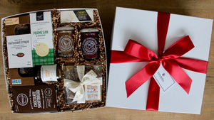 A sophisticated gourmet gift box by Perfect Baskets is filled with artisanal, small batch goodies to make a lovely charcuterie board to share with friends and family.