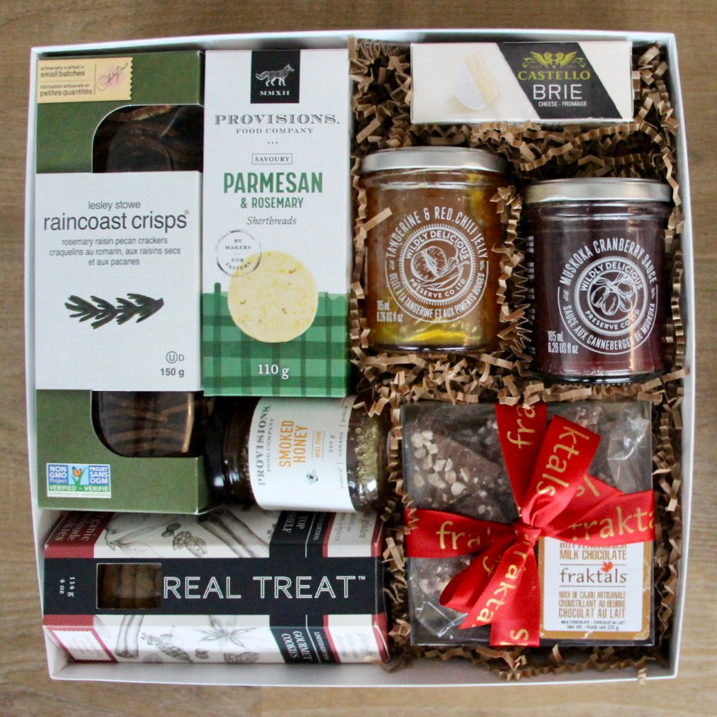 A sophisticated gourmet gift box filled with artisanal, small batch goodies to make a lovely charcuterie board