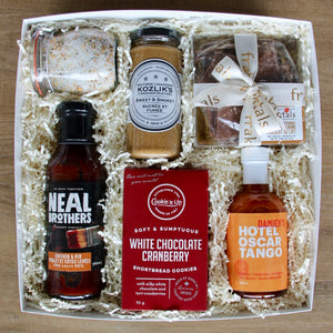 BBQ themed gift box with Neal Brother's BBQ sauce, Kozlik's mustard, Damien's hot sauce, Wildly Delicious butcher salts, Fraktals chocolate butterbrunch, and chocolate shortbread. Perfect gift for the BBQ lover with a sweet-tooth any time of the year!