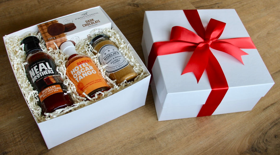 BBQ themed gift box with high quality BBQ sauces, Kozlik's mustard, Damien's hot sauce and Provisions Food Co dark chocolate shortbreads. Perfect little gift to bring to your next barbeque party!